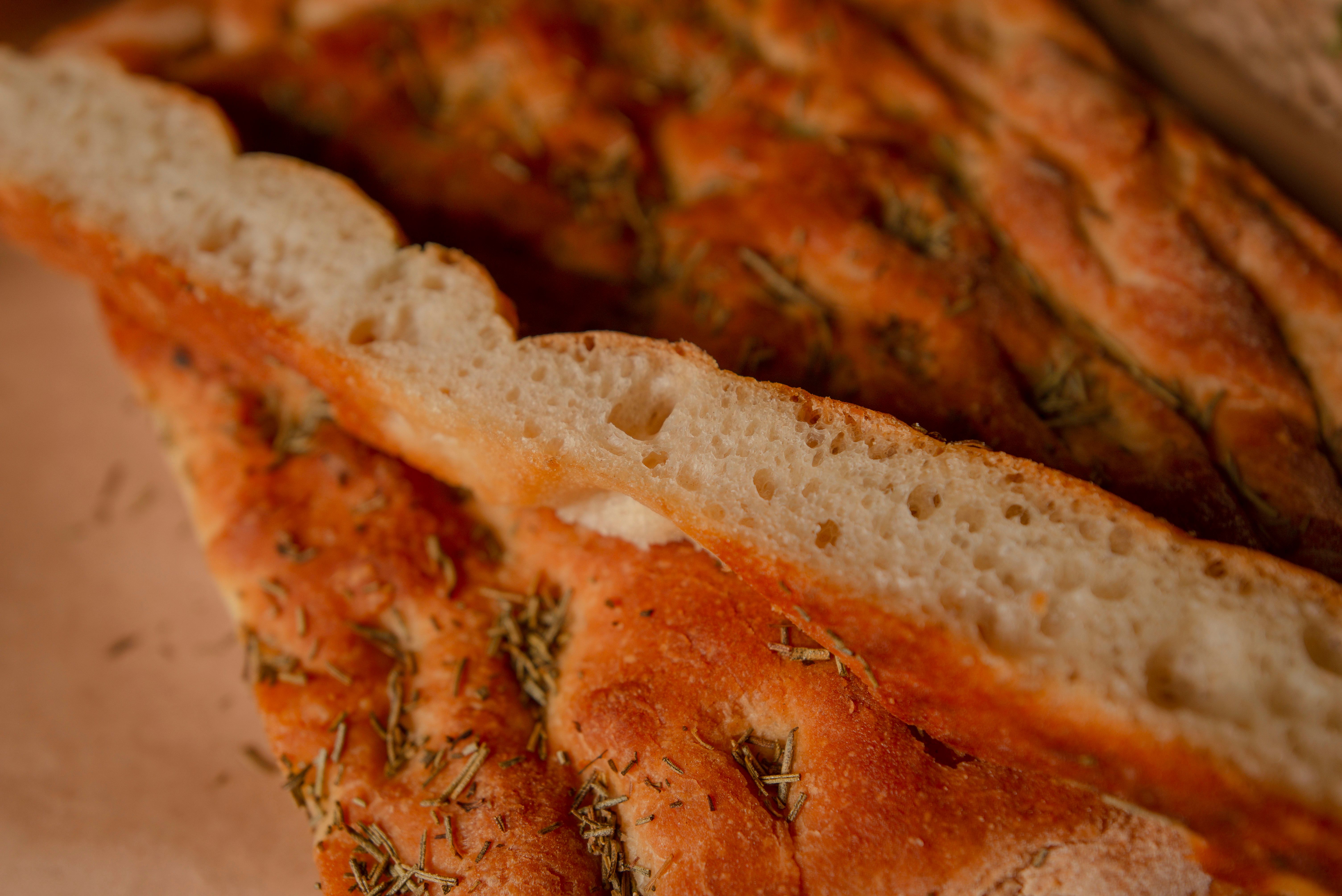 Focaccia genovese fresh from the oven, golden and dimpled with coarse salt visible