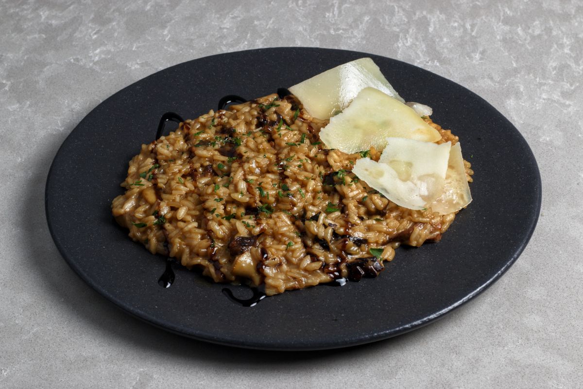 Creamy porcini risotto with a garnish of fresh thyme